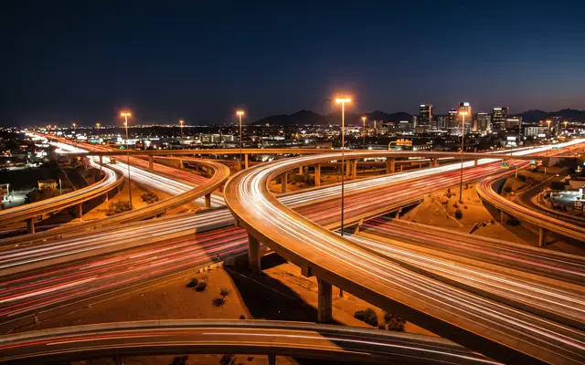 Night traffic light trails across a Phoenix freeway interchange